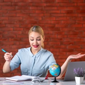 front view of travel agent taking notes behind her working place assistant map professional workout agency athlete occupation sport job manager